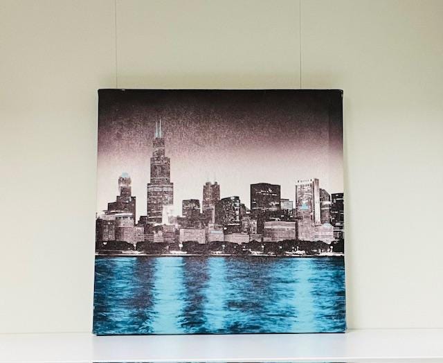 City Lights Art Set- Chicago Skyline canvas art, ceramic grey pot, black wood candle holder and books.